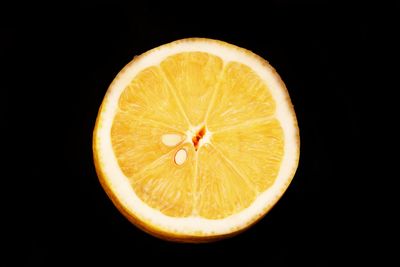 Close-up of lemon slice against black background