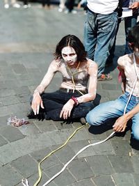 People sitting on footpath