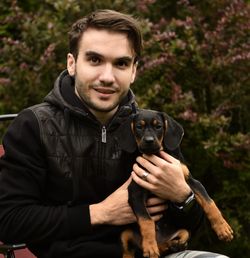 Portrait of a smiling young man with dog