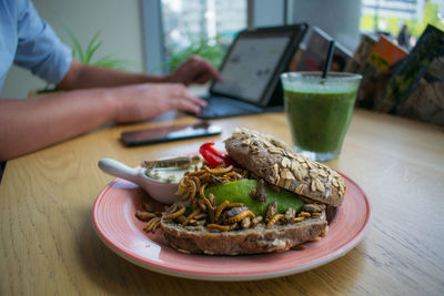 Burger in plate on table at home