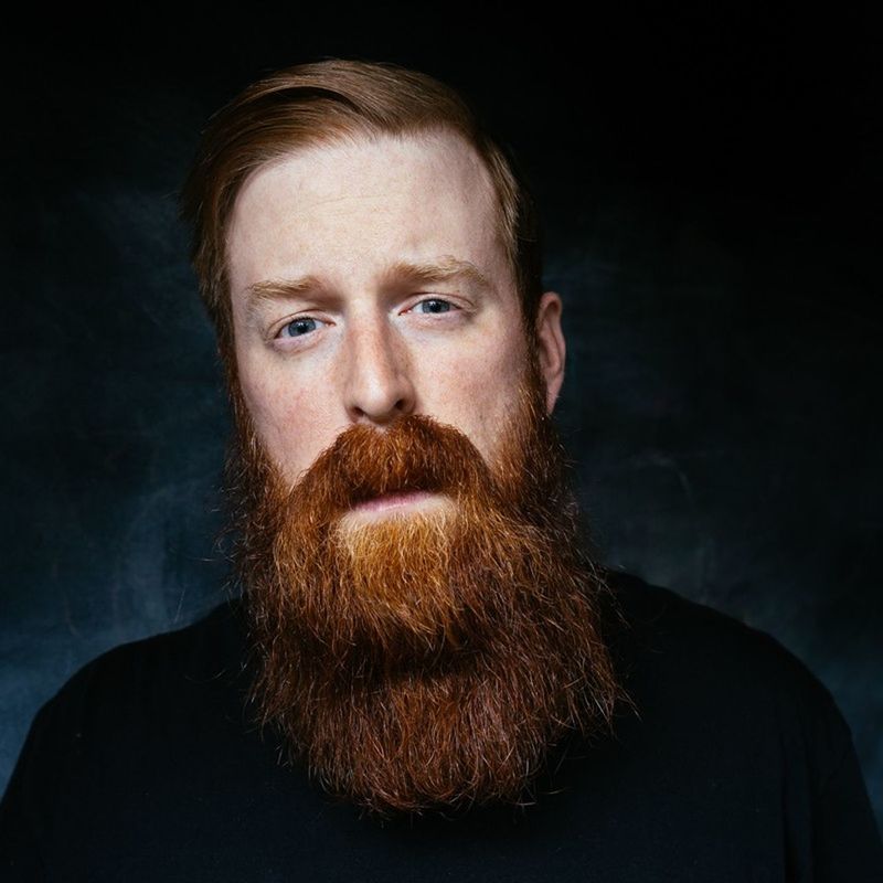 young adult, portrait, looking at camera, headshot, studio shot, person, front view, young men, lifestyles, black background, serious, beard, close-up, mid adult, leisure activity, indoors, contemplation, human face