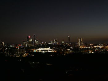 High angle view of illuminated buildings in city at night