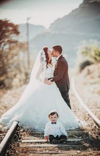 Rear view of couple holding hands