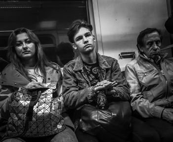Portrait of a smiling young woman sitting in train