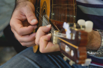 Midsection of man playing piano