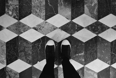 Low section of woman standing on tiled floor