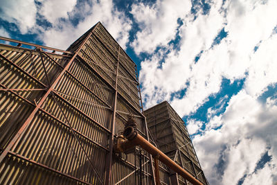 Low angle view of building against cloudy sky