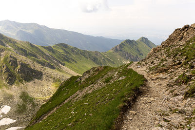 Hiking trail in the high mountain., with sharp rocks next to the trail.