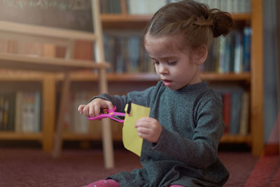 Boy holding book at home