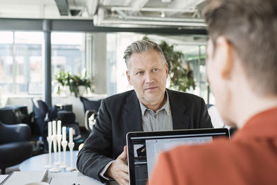 Businessman looking at colleague during meeting