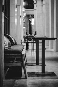 Empty chairs and tables in illuminated building