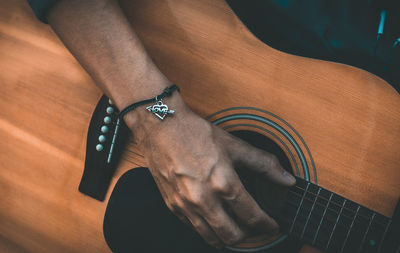 High angle view of man playing guitar