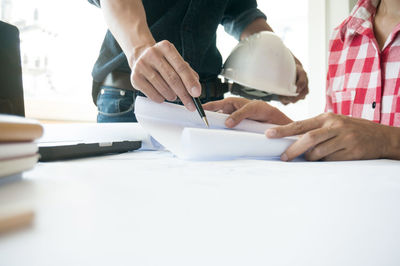 Low angle view of people working on table