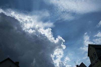 Low angle view of building against cloudy sky