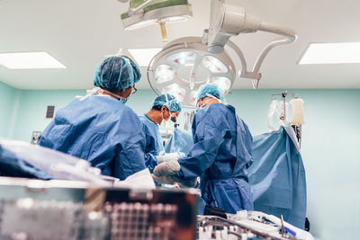 Surgeons performing surgery in operating room