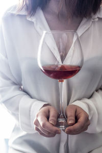 Close-up of man holding wine glass