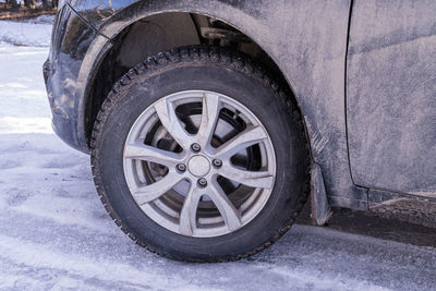 A car wheel with spikes in the snow