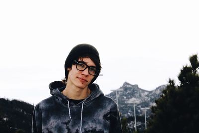 Portrait of young man against clear sky