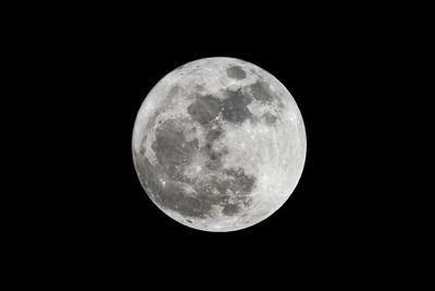 Low angle view of full moon against sky at night