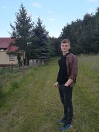 Full length of young man standing on field