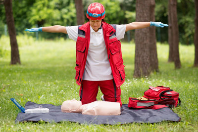 Healthcare worker practicing on cpr dummy at park