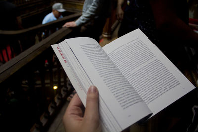 Cropped hand of person holding book