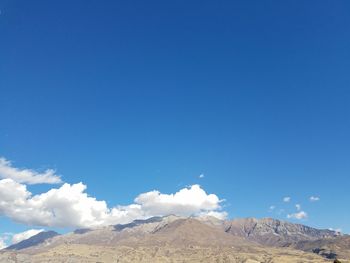 Scenic view of desert against blue sky