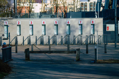 Row of chairs on street against buildings in city