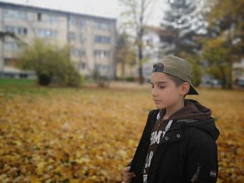 Boy looking away on field