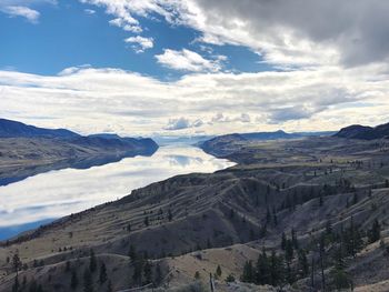 Scenic view of snowcapped mountains against cloudy sky