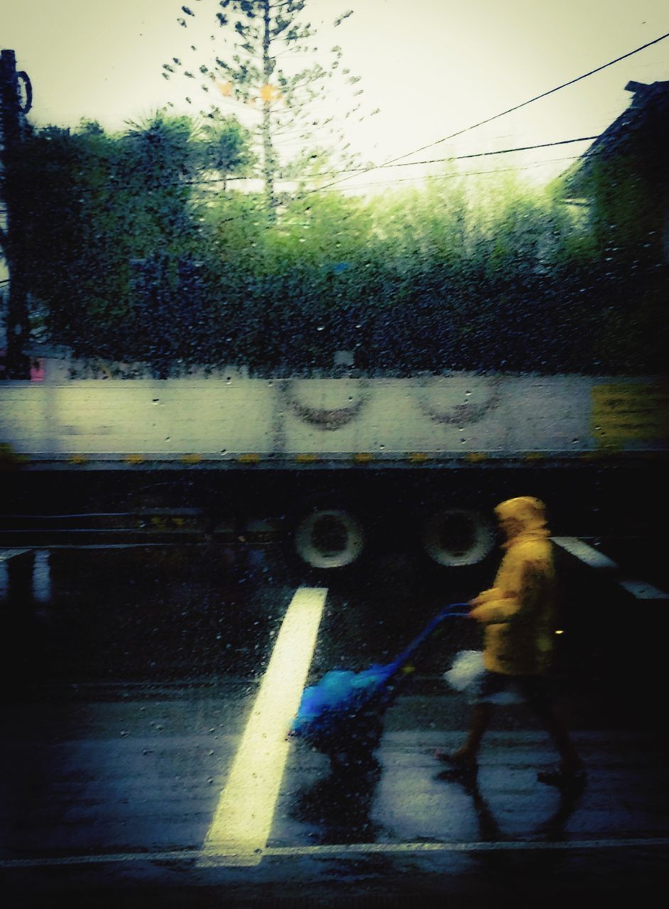 transportation, lifestyles, mode of transport, leisure activity, land vehicle, on the move, road, street, full length, motion, men, rear view, tree, blurred motion, wet, travel, car, riding