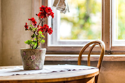 Close-up of flower vase on table at home