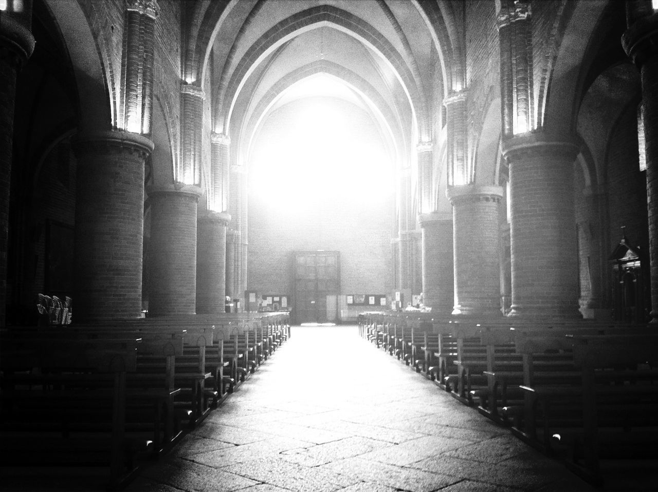 indoors, architecture, place of worship, religion, the way forward, built structure, arch, church, corridor, spirituality, diminishing perspective, empty, in a row, architectural column, cathedral, pew, interior, history