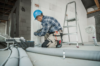 Side view of man working in workshop