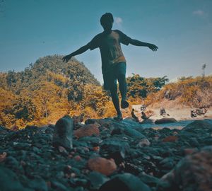 Full length of man standing on rock