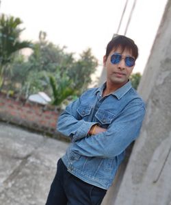 Portrait of man wearing sunglasses standing outdoors