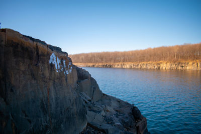 Panoramic view of rocks against clear blue sky