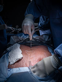 Midsection of man working on bed