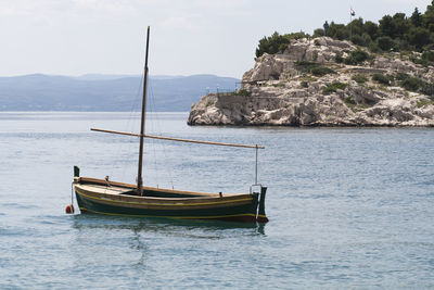 Sailboat on sea against sky