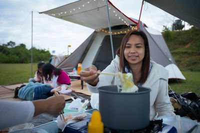 Woman sitting on table at outdoor cafe