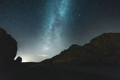 Scenic view of rock formation against sky at night