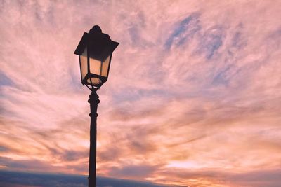 Low angle view of street light against orange sky