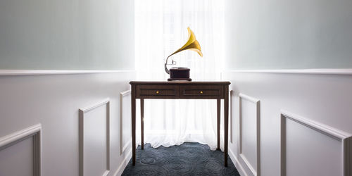 Gramophone on table amidst walls at home
