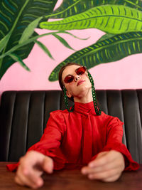 Low angle view of young woman wearing sunglasses