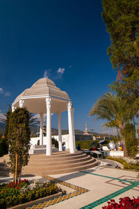 View of swimming pool building against blue sky