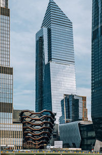 Low angle view of modern buildings against sky in city