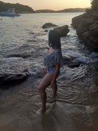 Full length of woman on rock at beach