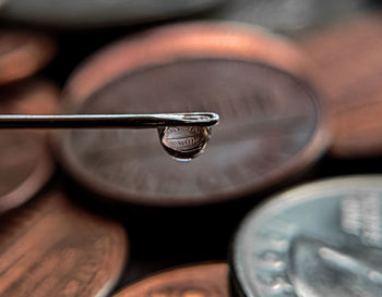 Close-up of water drop on metal