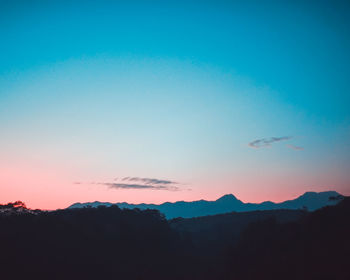 Scenic view of silhouette mountains against clear sky