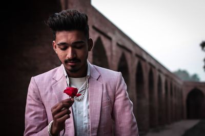 Portrait of young man standing outdoors